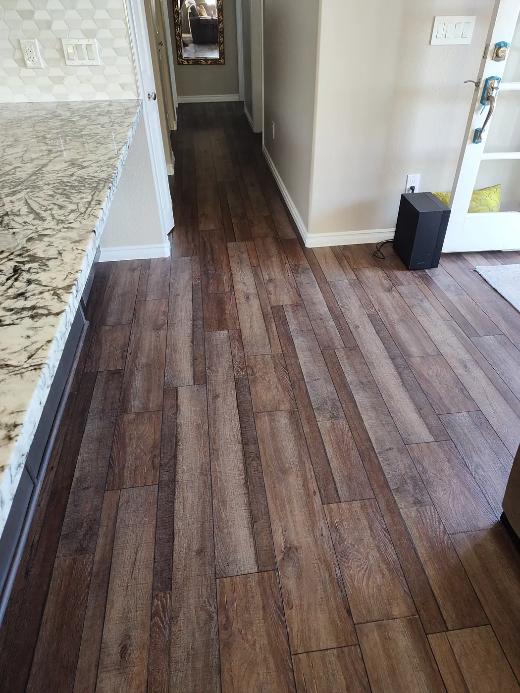 Wood-look plank flooring installation in a Maui home by Can Can Builders